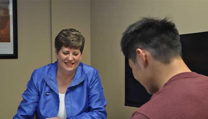 Brooke with students in her office